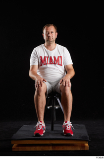 Louis  2 dressed grey shorts red sneakers sitting sports…